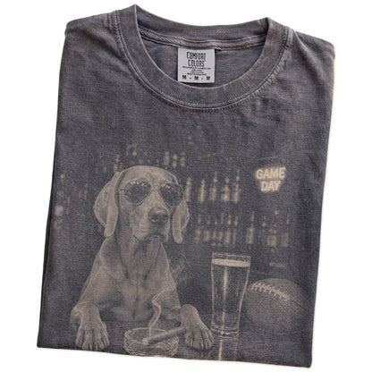 Folded Pepper Comfort Colors® T-shirt showing Weimaraner with beer and football graphics