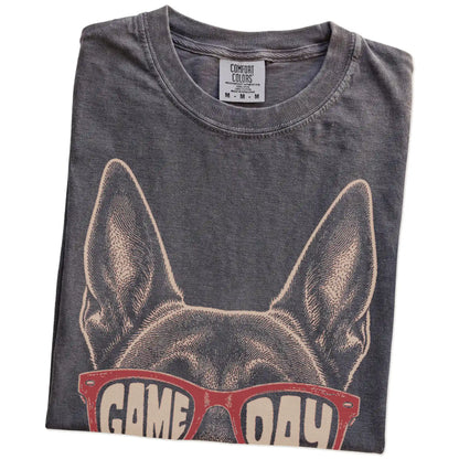 Folded Pepper Comfort Colors® T-shirt showing belgian malinois wearing red game day sunglasses
