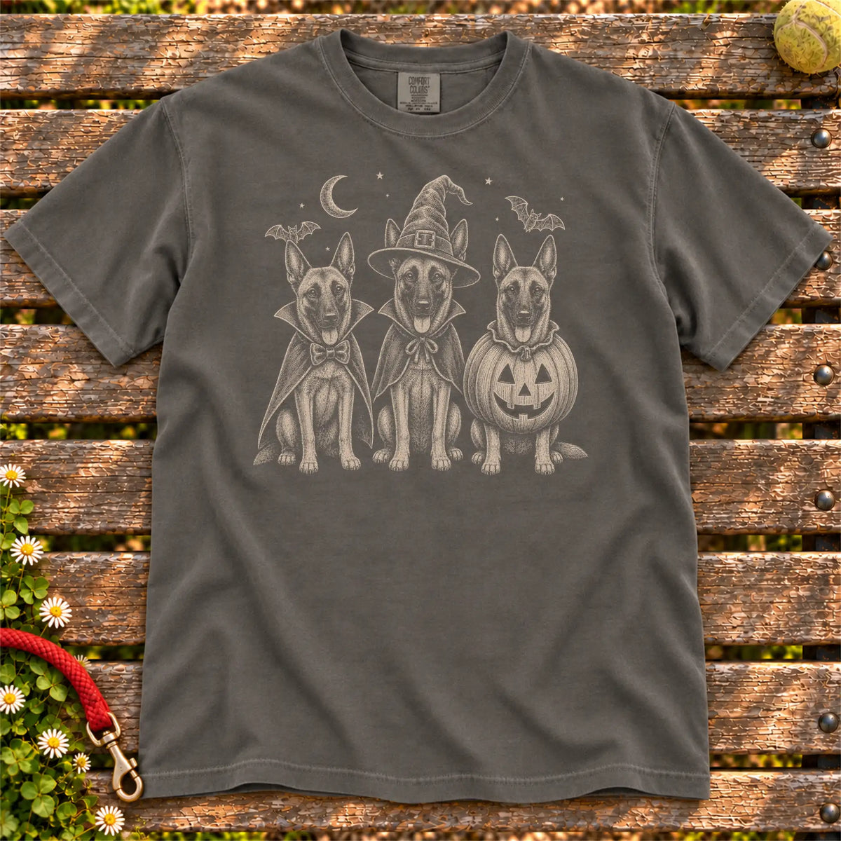 Three Belgian Malinois dogs dressed for Halloween beneath bats and a crescent moon on a Pepper Comfort Colors® T-shirt