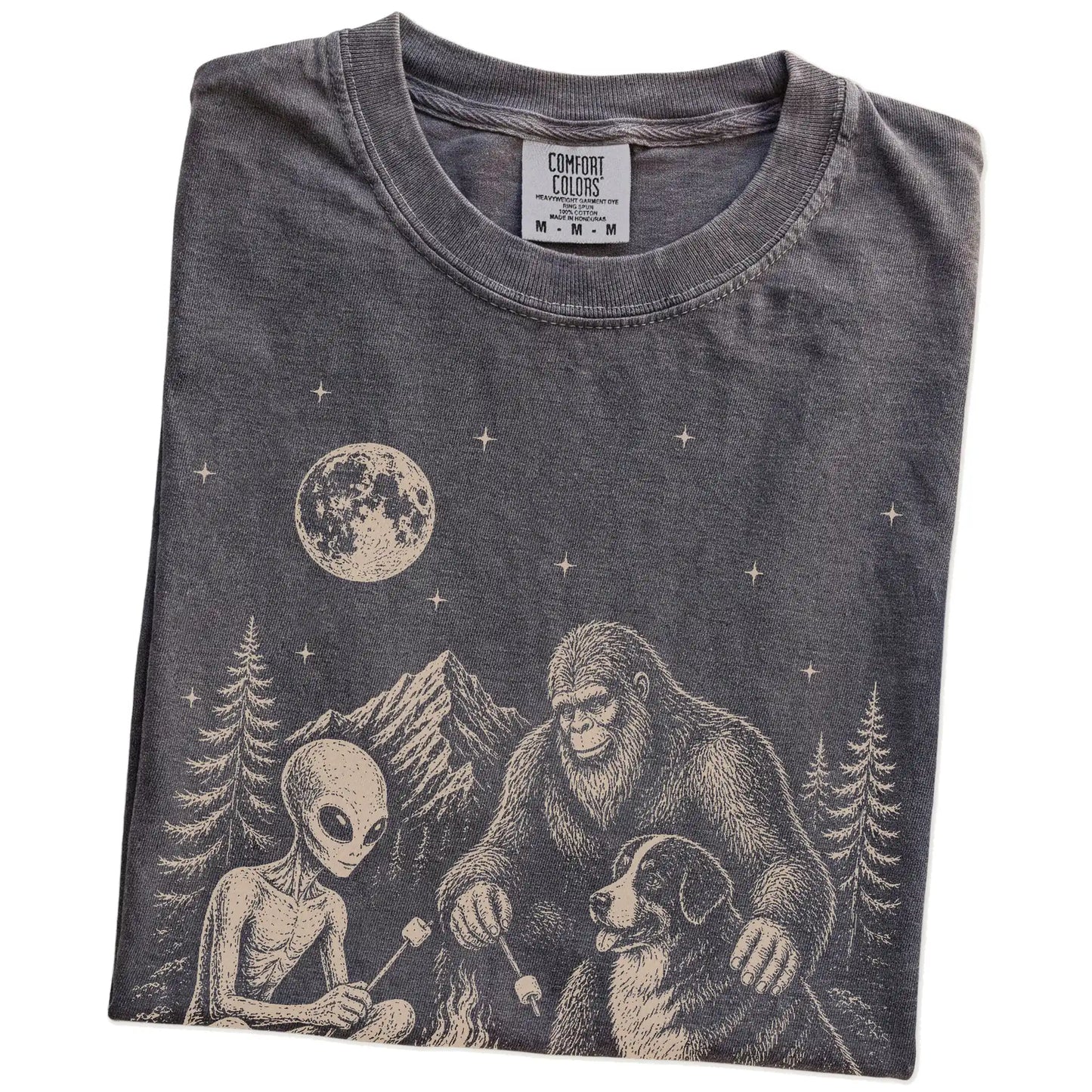 Folded Pepper Comfort Colors® T-shirt showing Bernese Mountain Dog camping with Bigfoot and an alien