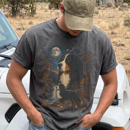 Model wearing a Pepper Comfort Colors® t-shirt featuring Bernese Mountain Dog in a moonlit fall forest