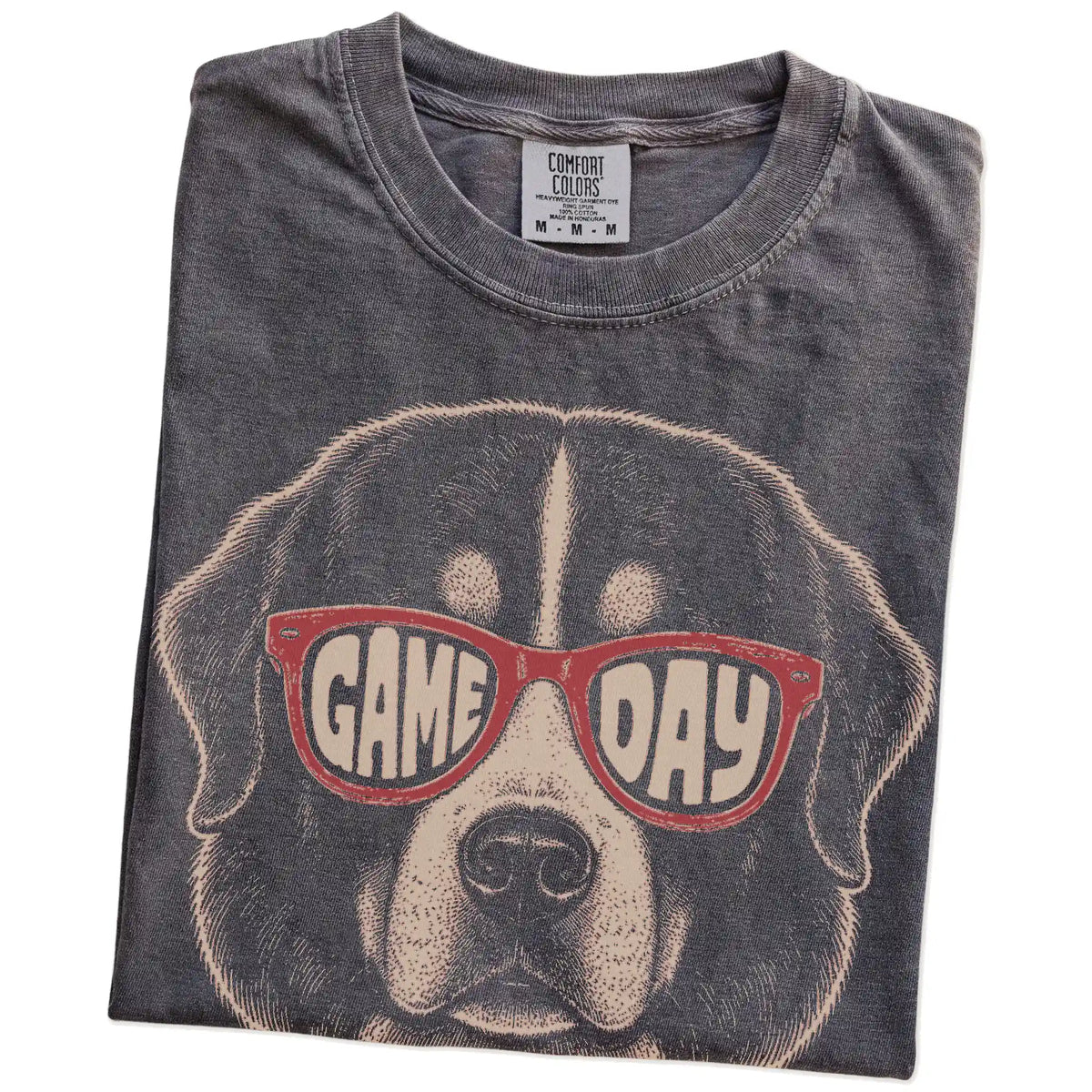 Folded Pepper Comfort Colors® T-shirt showing bernese mountain dog wearing red game day sunglasses