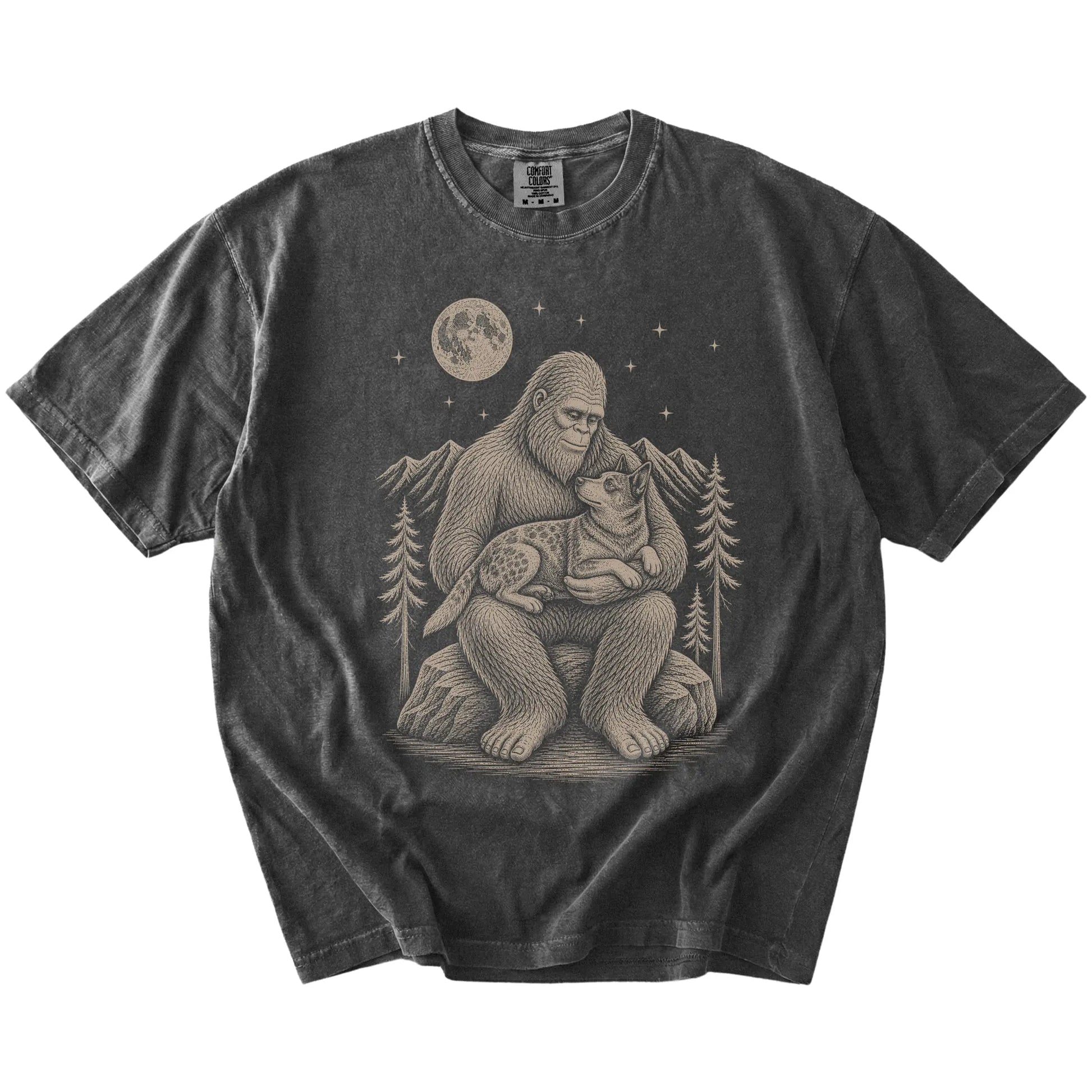 Bigfoot holding a Blue Heeler on a Pepper Comfort Colors® T-shirt