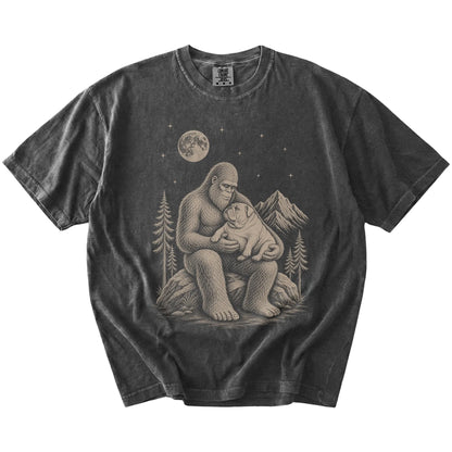 Bigfoot holding a Bulldog on a Pepper Comfort Colors® T-shirt