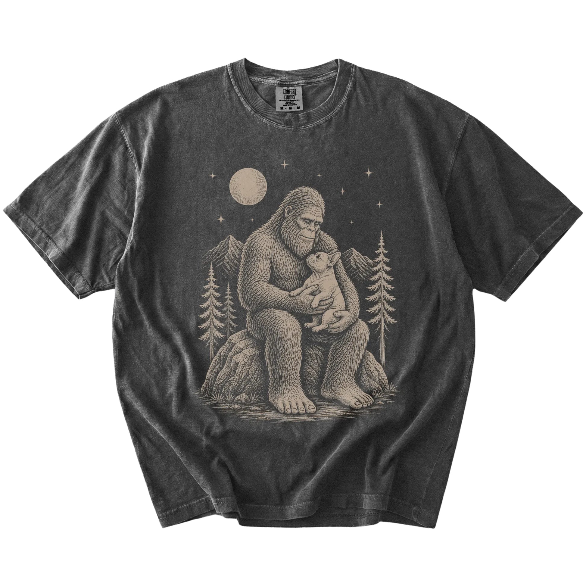 Bigfoot holding a French Bulldog on a Pepper Comfort Colors® T-shirt