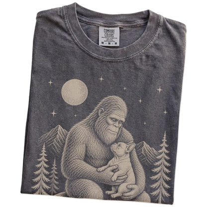 Folded Pepper Comfort Colors® T-shirt showing Bigfoot holding a French Bulldog