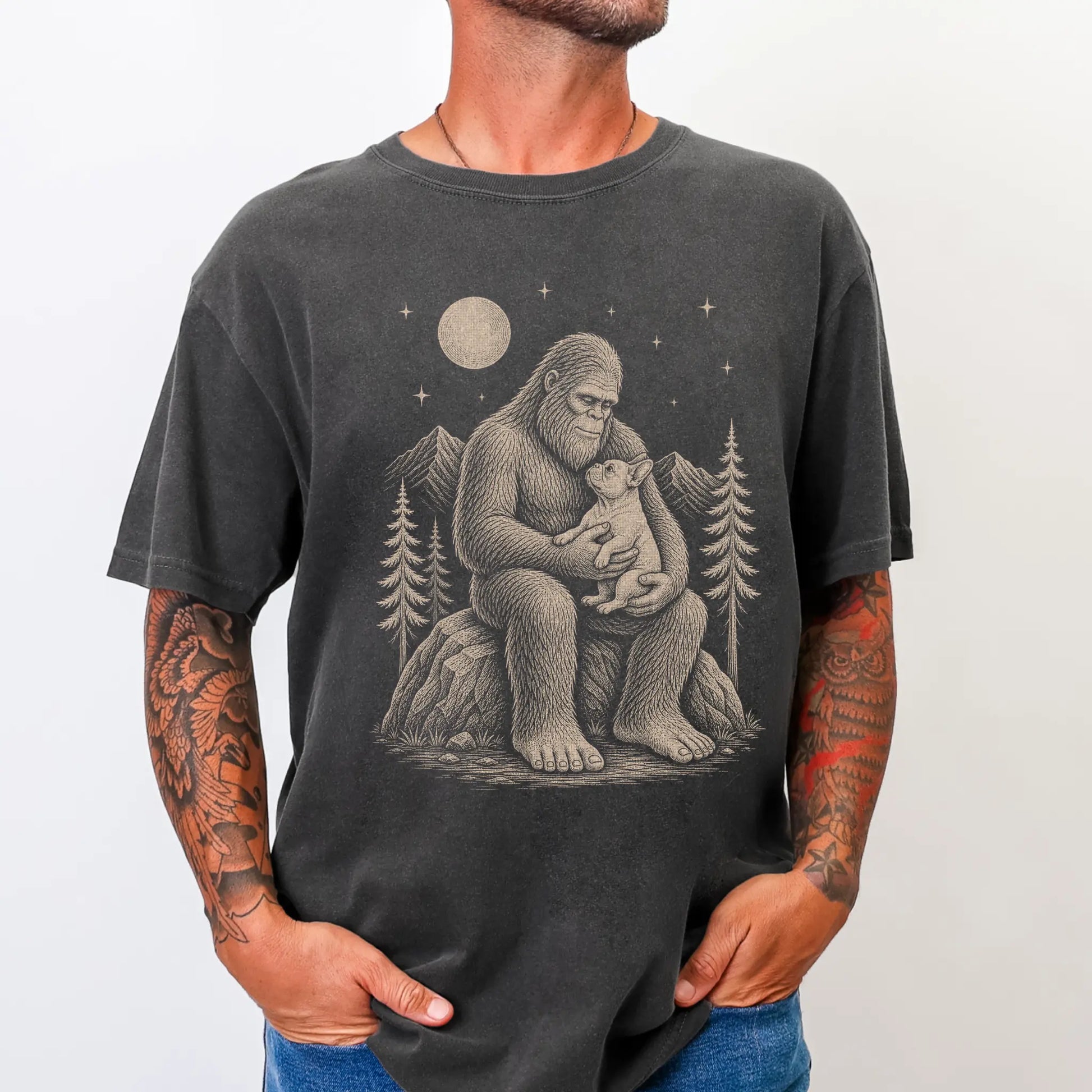 Model wearing a Pepper Comfort Colors® T-shirt showing Bigfoot holding a French Bulldog