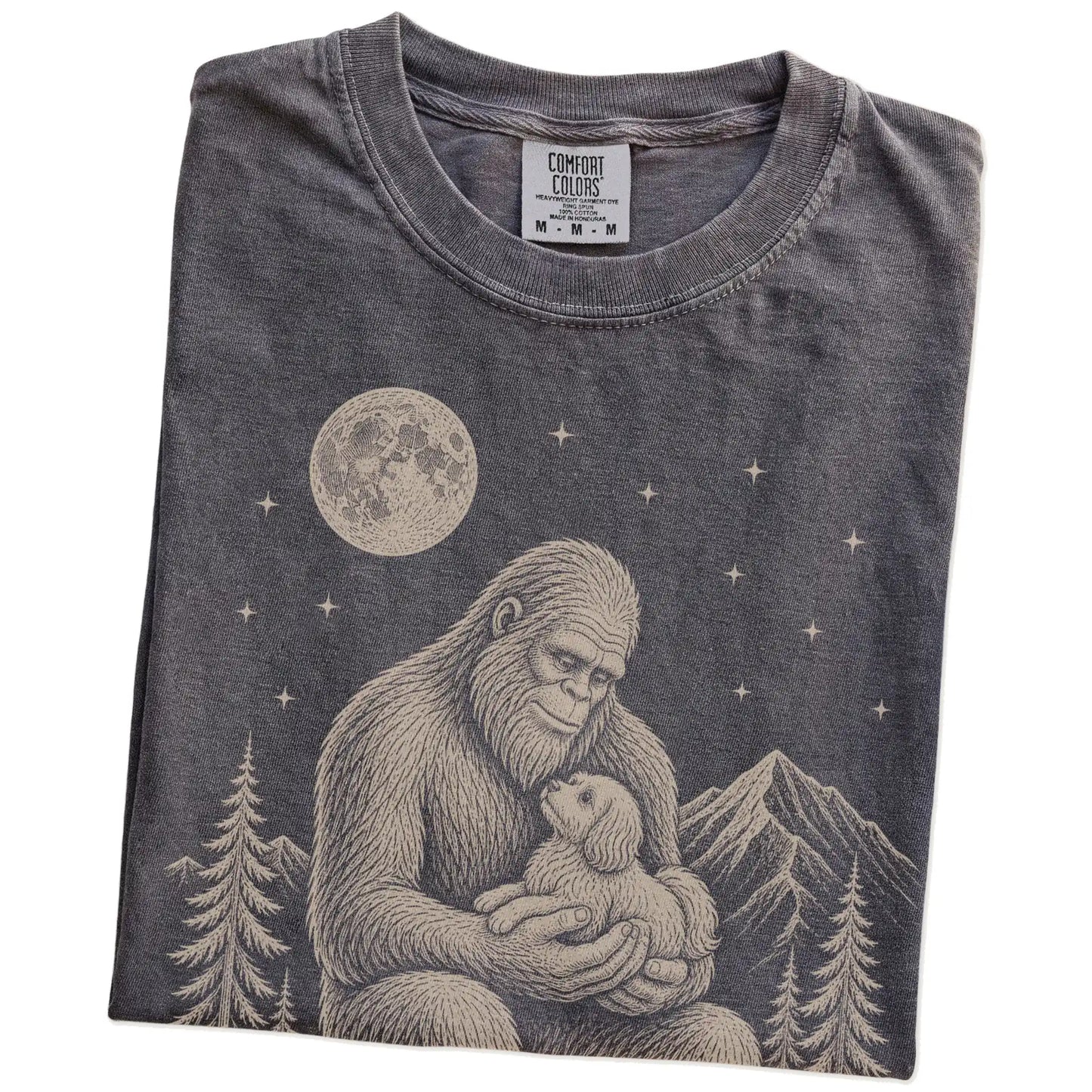 Folded Pepper Comfort Colors® T-shirt showing Bigfoot holding a Havanese