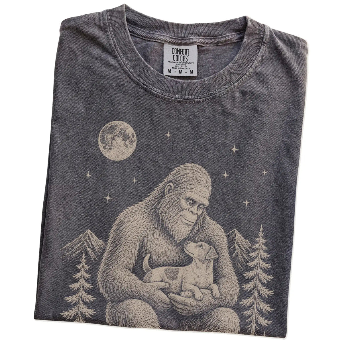 Folded Pepper Comfort Colors® T-shirt showing Bigfoot holding a Jack Russell