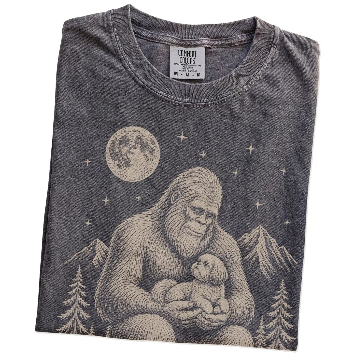 Folded Pepper Comfort Colors® T-shirt showing Bigfoot holding a Shih Tzu