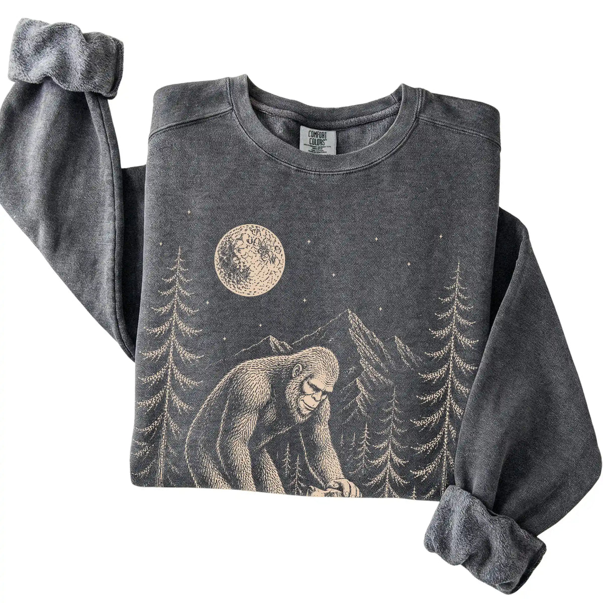 Pepper Comfort Colors sweatshirt featuring Bigfoot petting a Blue Heeler