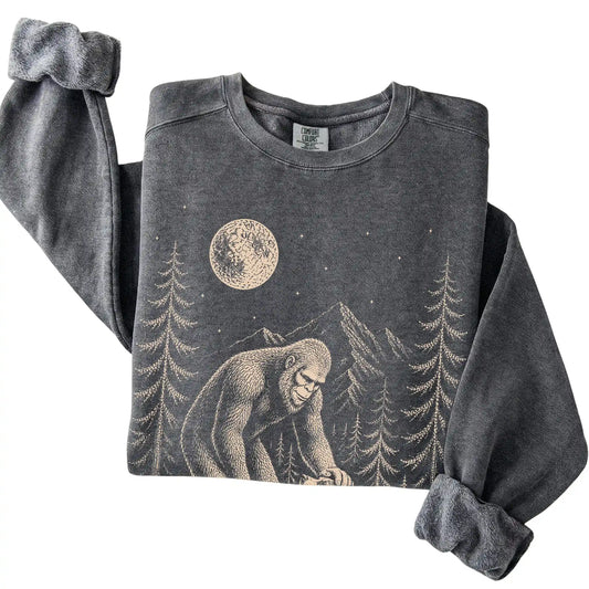 Pepper Comfort Colors sweatshirt featuring Bigfoot petting a Blue Heeler