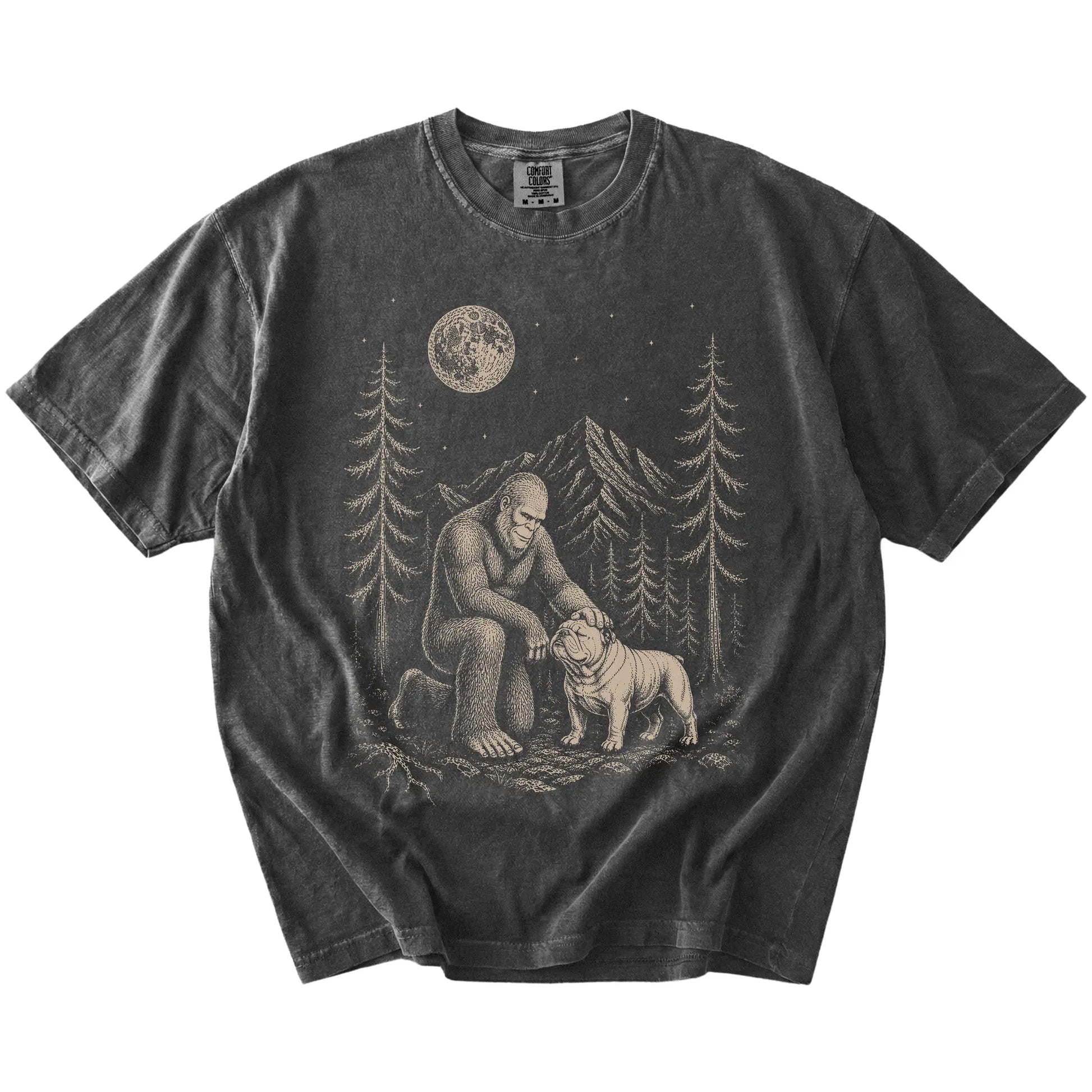 Bigfoot petting a Bulldog beneath the moon in a pine forest on a Pepper Comfort Colors® T-shirt