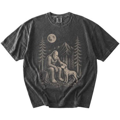 Bigfoot petting a Dalmatian beneath the moon in a pine forest on a Pepper Comfort Colors® T-shirt