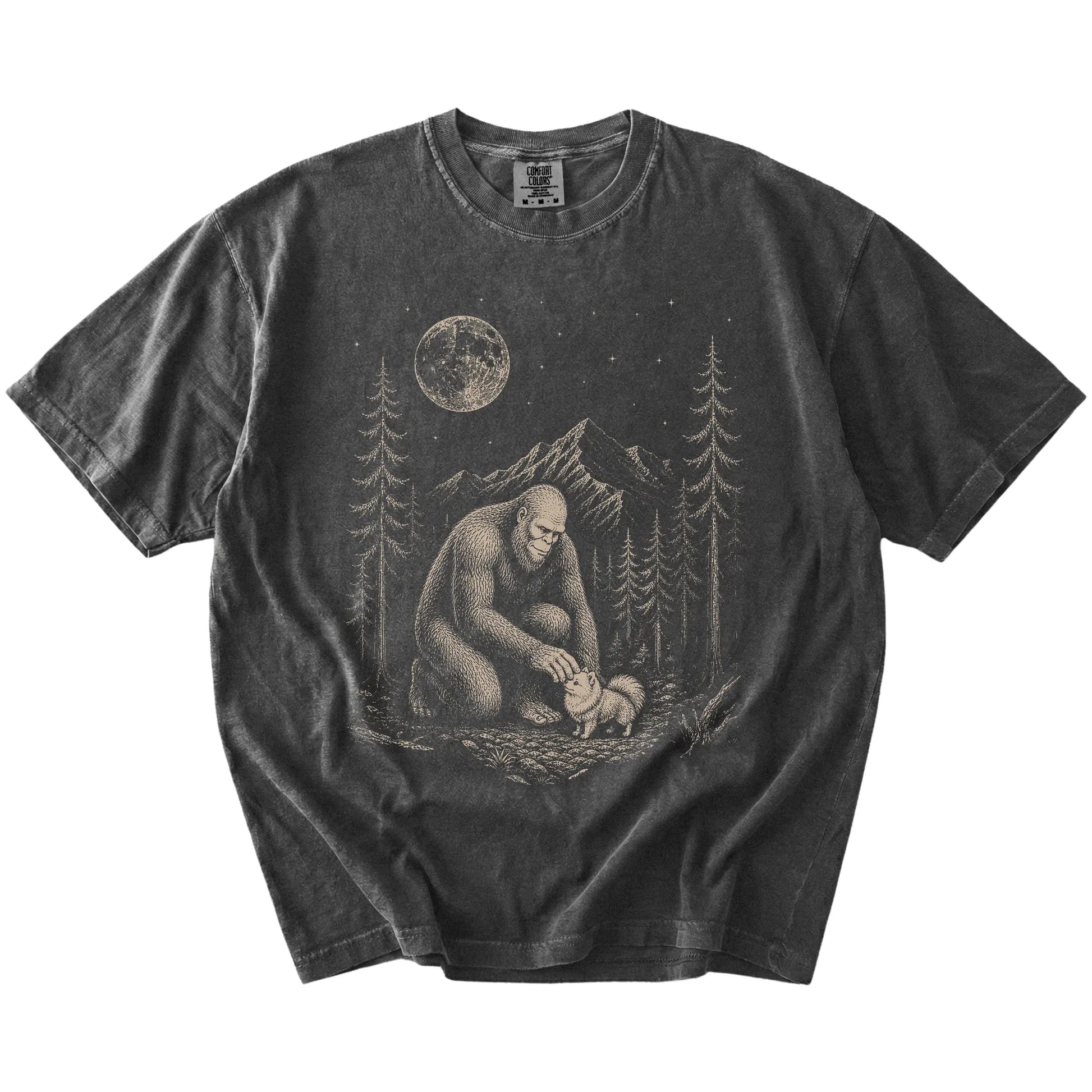 Bigfoot petting a Pomeranian beneath the moon in a pine forest on a Pepper Comfort Colors® T-shirt