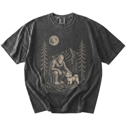 Bigfoot petting a Shih Tzu beneath the moon in a pine forest on a Pepper Comfort Colors® T-shirt