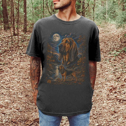 Model wearing a Pepper Comfort Colors® t-shirt featuring Bloodhound in a moonlit fall forest