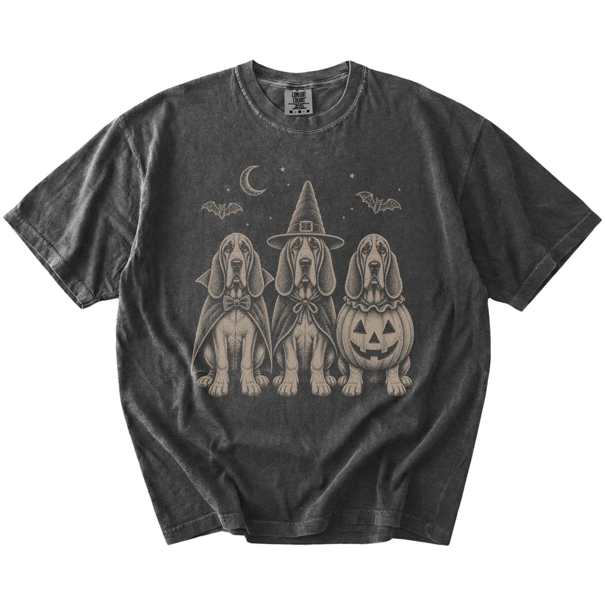 Three Bloodhound dogs dressed for Halloween beneath bats and a crescent moon on a Pepper Comfort Colors® T-shirt