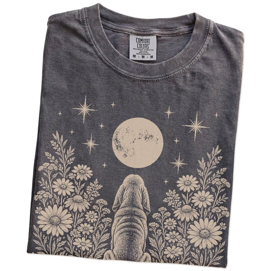Folded Pepper Comfort Colors® T-shirt showing Bloodhound beneath a wildflower moon