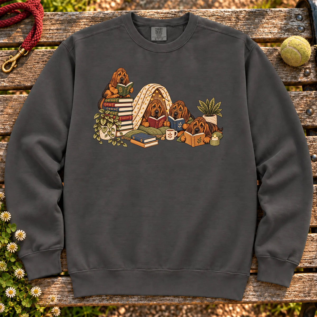 Bloodhound puppies reading books in a cozy blanket fort on a Pepper sweatshirt