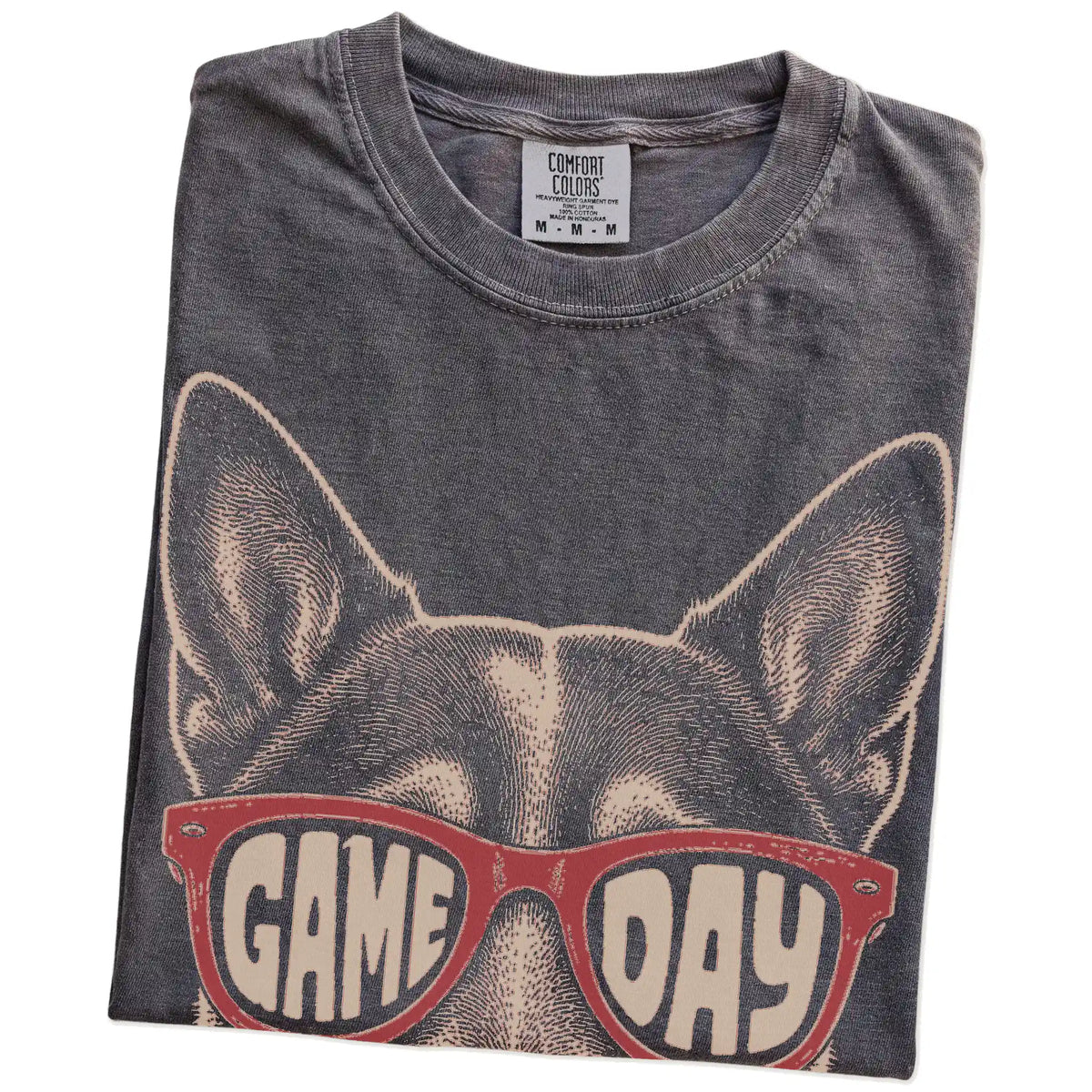 Folded Pepper Comfort Colors® T-shirt showing blue heeler wearing red game day sunglasses