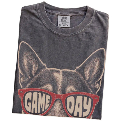 Folded Pepper Comfort Colors® T-shirt showing blue heeler wearing red game day sunglasses