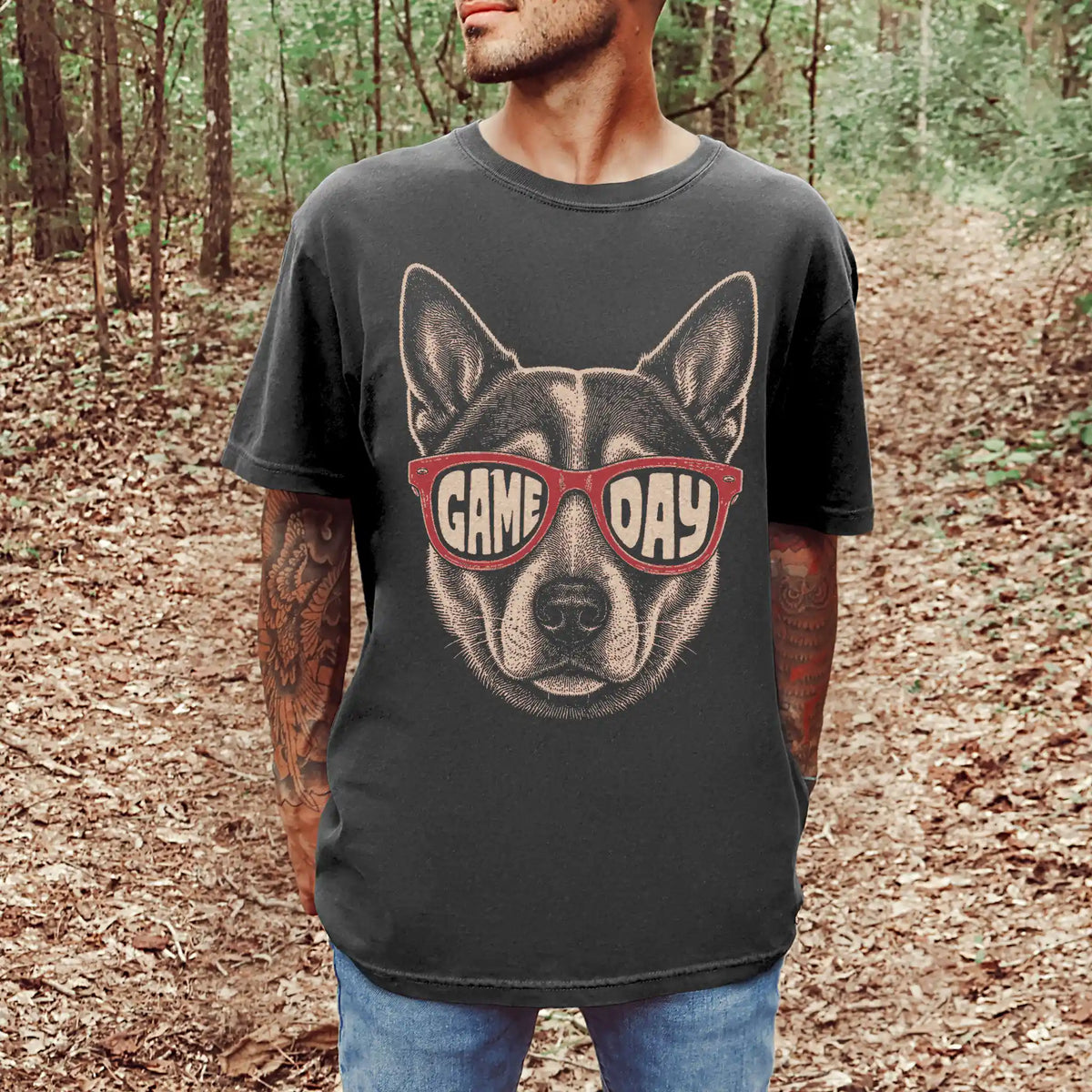 Model wearing a Pepper Comfort Colors® T-shirt with blue heeler wearing red game day sunglasses