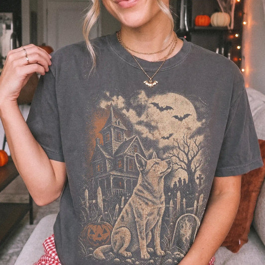 Model wearing a Pepper Comfort Colors® T-shirt showing Blue Heeler in a vintage haunted-house scene
