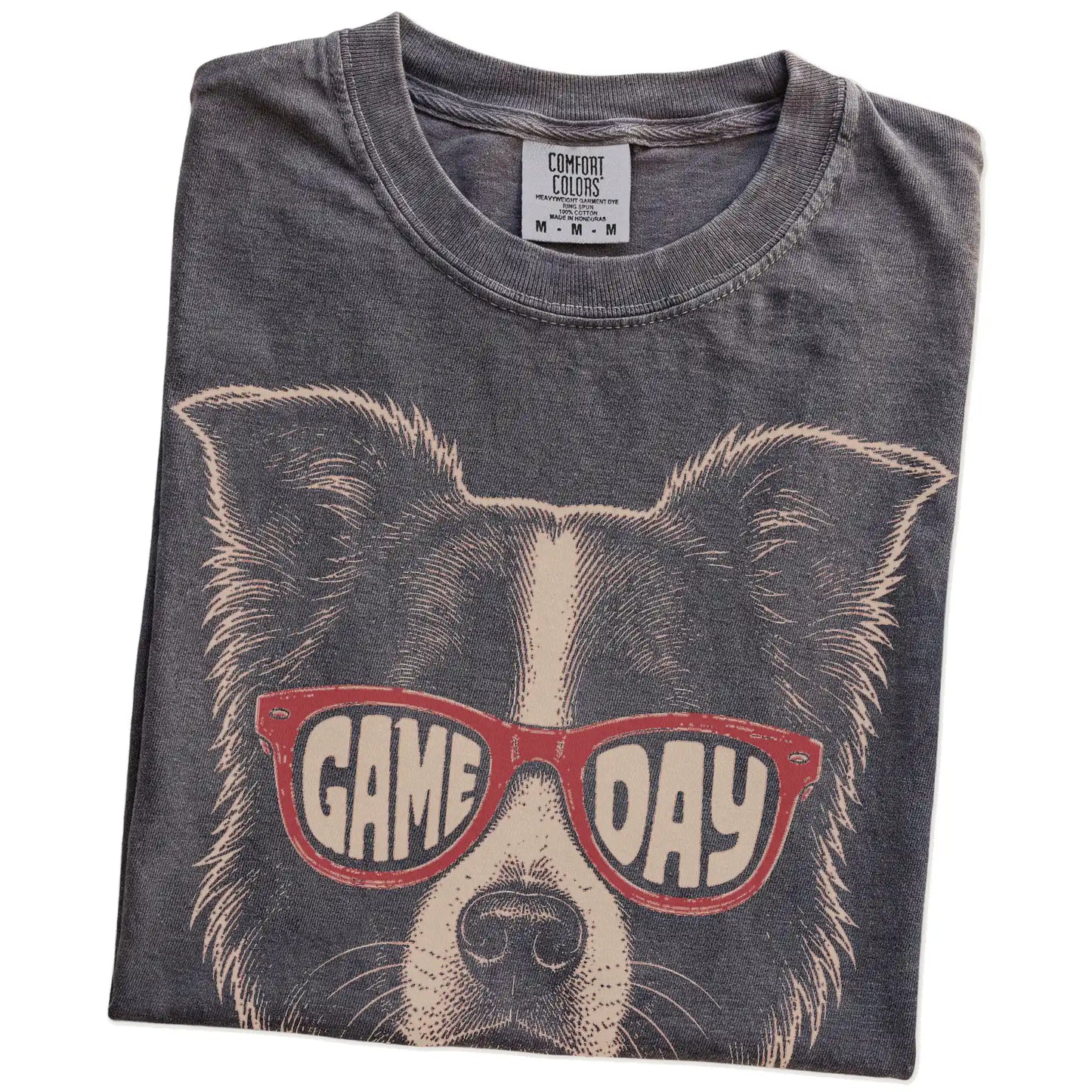 Folded Pepper Comfort Colors® T-shirt showing border collie wearing red game day sunglasses