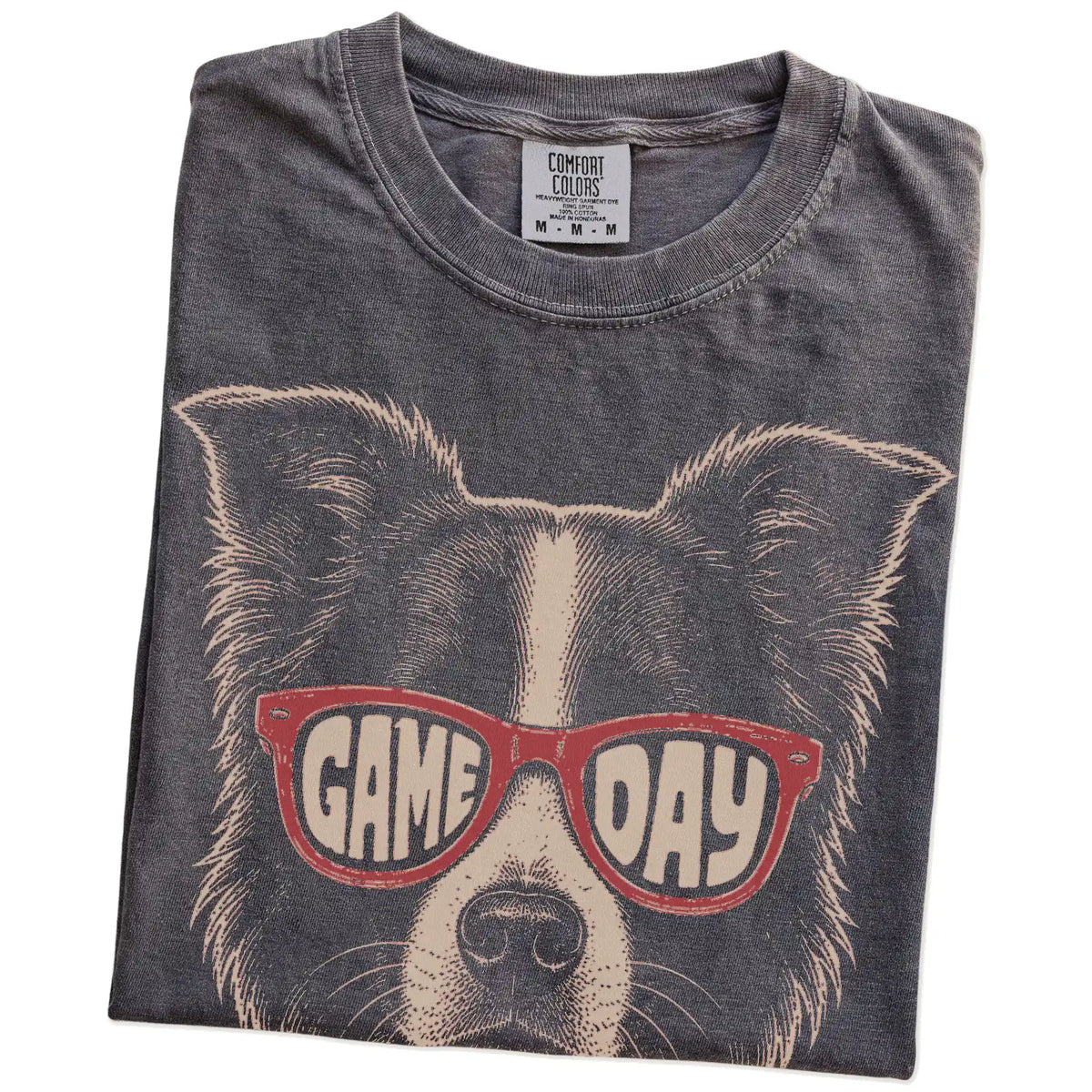 Folded Pepper Comfort Colors® T-shirt showing border collie wearing red game day sunglasses