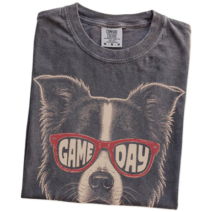 Folded Pepper Comfort Colors® T-shirt showing border collie wearing red game day sunglasses