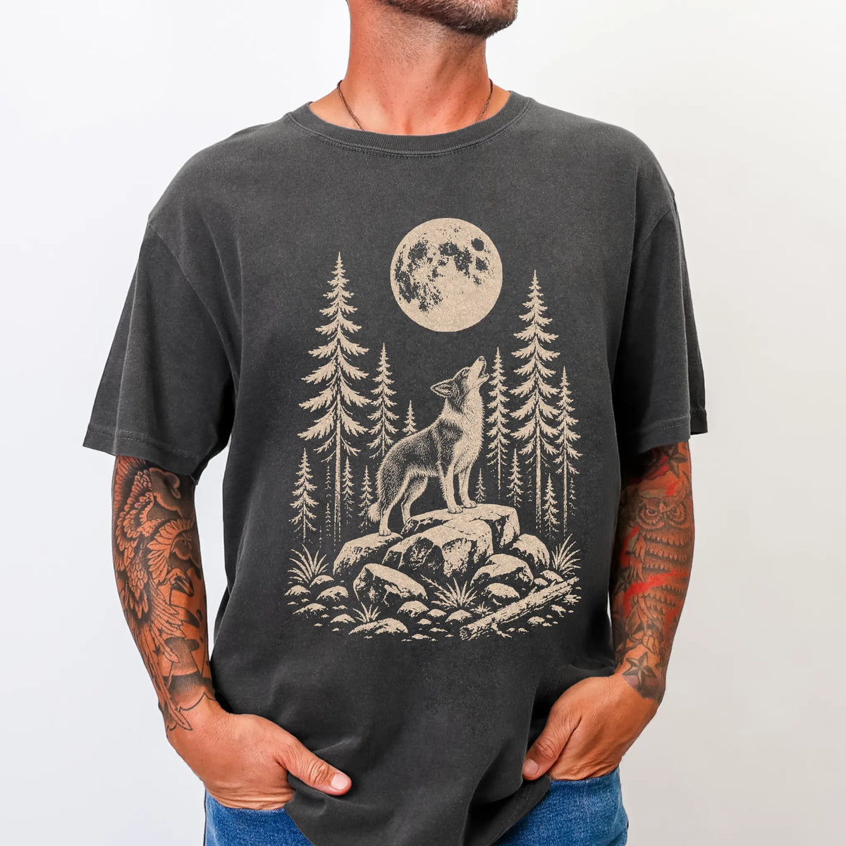 Model wearing a Pepper Comfort Colors® T-shirt with a Border Collie howling beneath the moon and pine trees