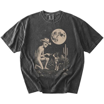 Cowboy alien fist-bumping a Boston Terrier beneath the moon on a Pepper Comfort Colors® T-shirt