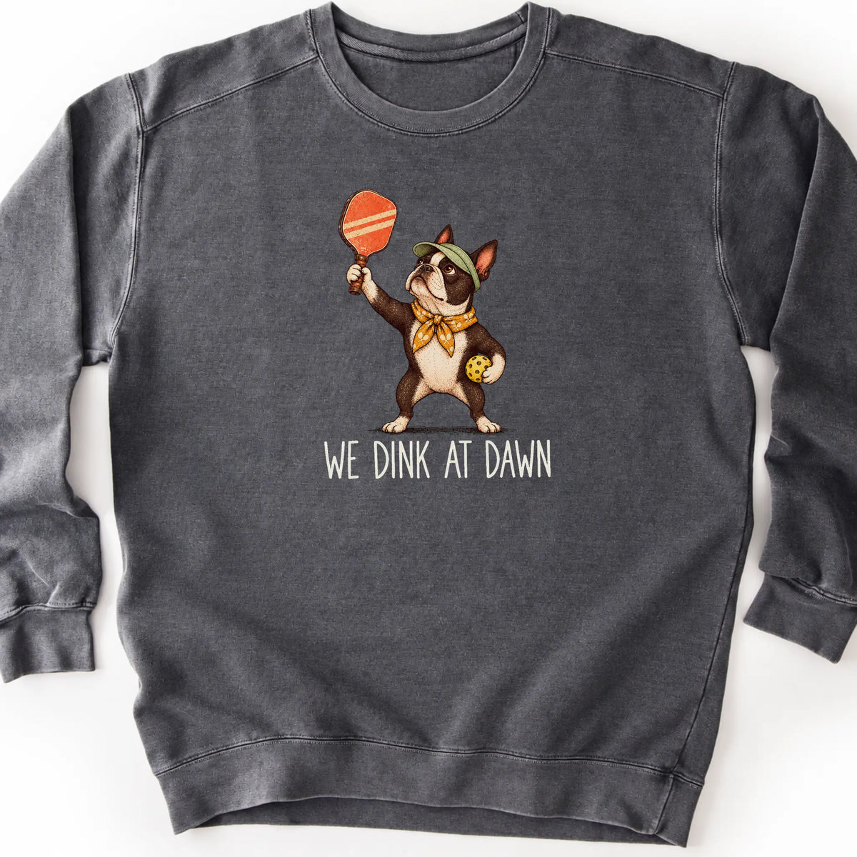 Boston Terrier with a pickleball paddle and ball on a Pepper Comfort Colors® sweatshirt with We Dink at Dawn text