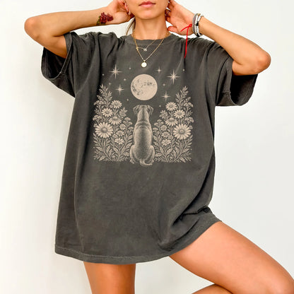 Model wearing a Pepper Comfort Colors® T-shirt featuring Boxer beneath a wildflower moon