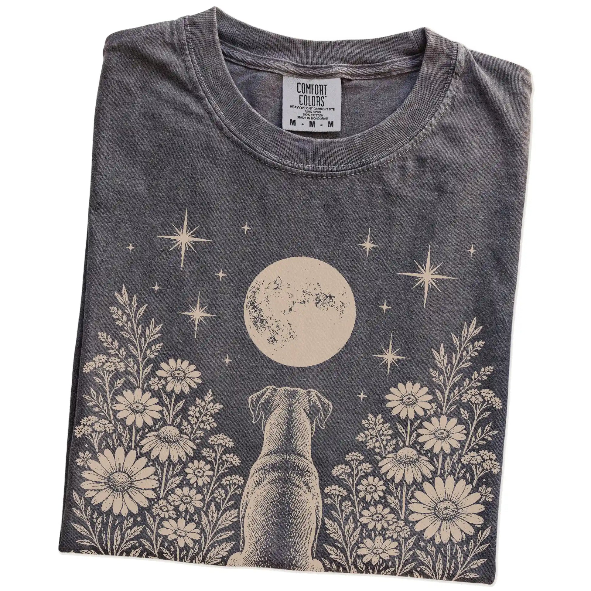 Folded Pepper Comfort Colors® T-shirt showing Boxer beneath a wildflower moon