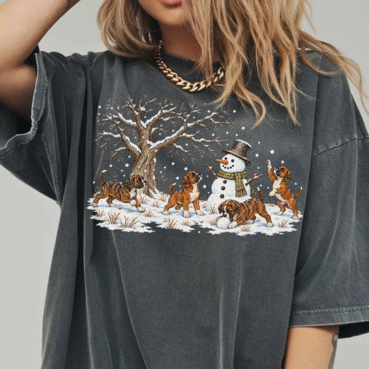Boxer puppies playing in snow with a snowman on a Pepper T-shirt worn by a model