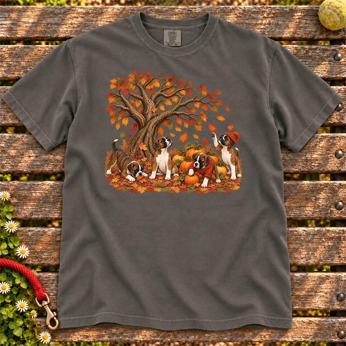 Four Boxer puppies with pumpkins beneath an autumn tree on a Pepper garment-dyed T-shirt