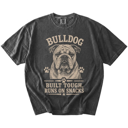 Bulldog design with “Built Tough, Runs On Snacks” lettering on a Pepper Comfort Colors® T-shirt