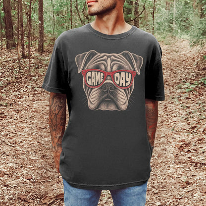 Model wearing a Pepper Comfort Colors® T-shirt with bulldog wearing red game day sunglasses