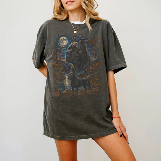 Model wearing a Pepper Comfort Colors® t-shirt featuring Cane Corso in a moonlit fall forest