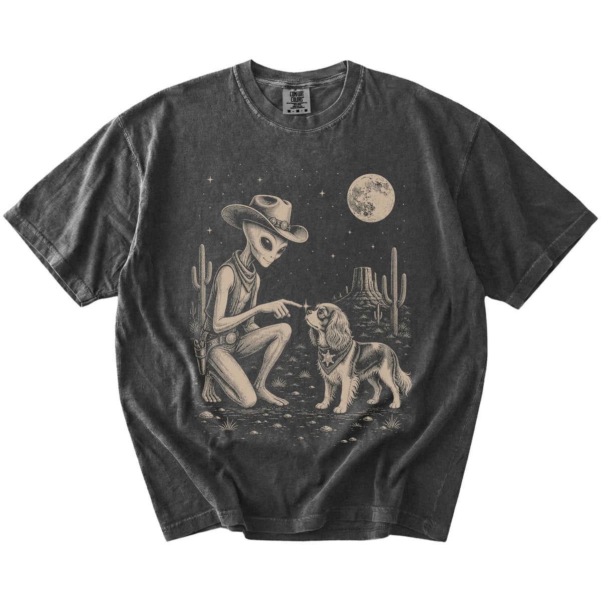 Cowboy alien fist-bumping a Cavalier King Charles Spaniel beneath the moon on a Pepper Comfort Colors® T-shirt