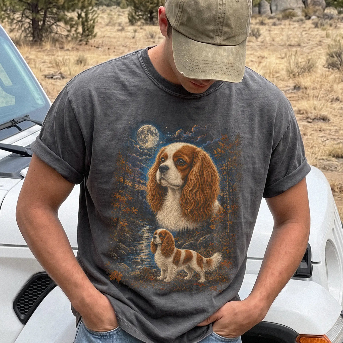 Model wearing a Pepper Comfort Colors® t-shirt featuring Cavalier King Charles Spaniel in a moonlit fall forest