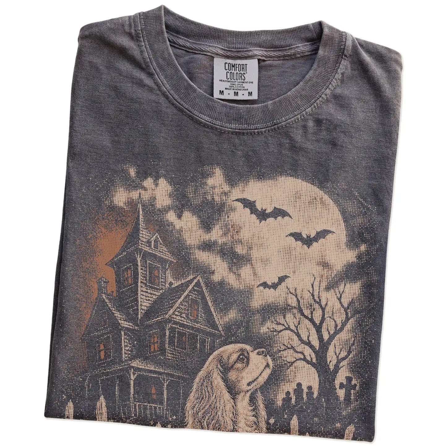 Folded Pepper Comfort Colors® T-shirt showing Cavalier King Charles Spaniel in a vintage haunted-house scene