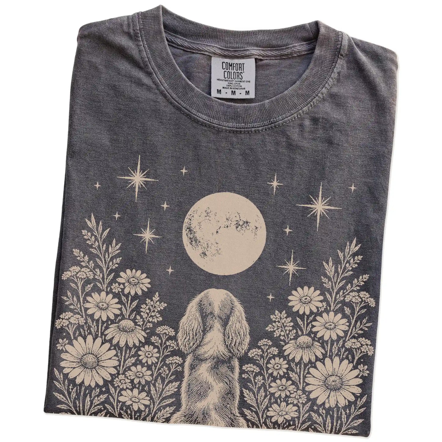 Folded Pepper Comfort Colors® T-shirt showing Cavalier King Charles Spaniel beneath a wildflower moon