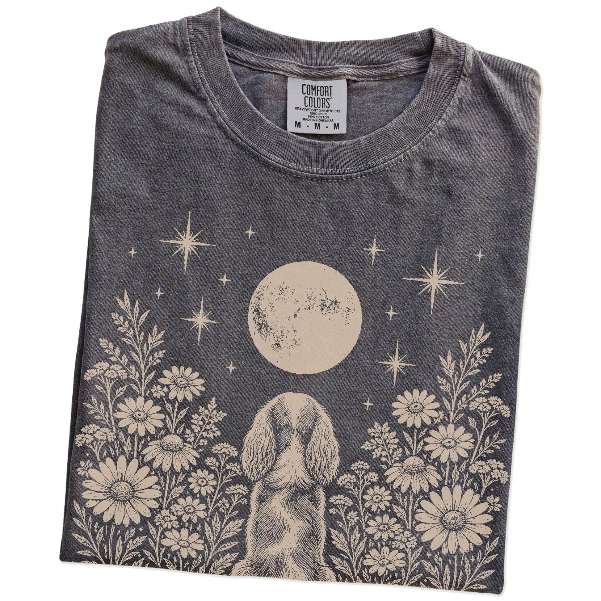 Folded Pepper Comfort Colors® T-shirt showing Cavalier King Charles Spaniel beneath a wildflower moon