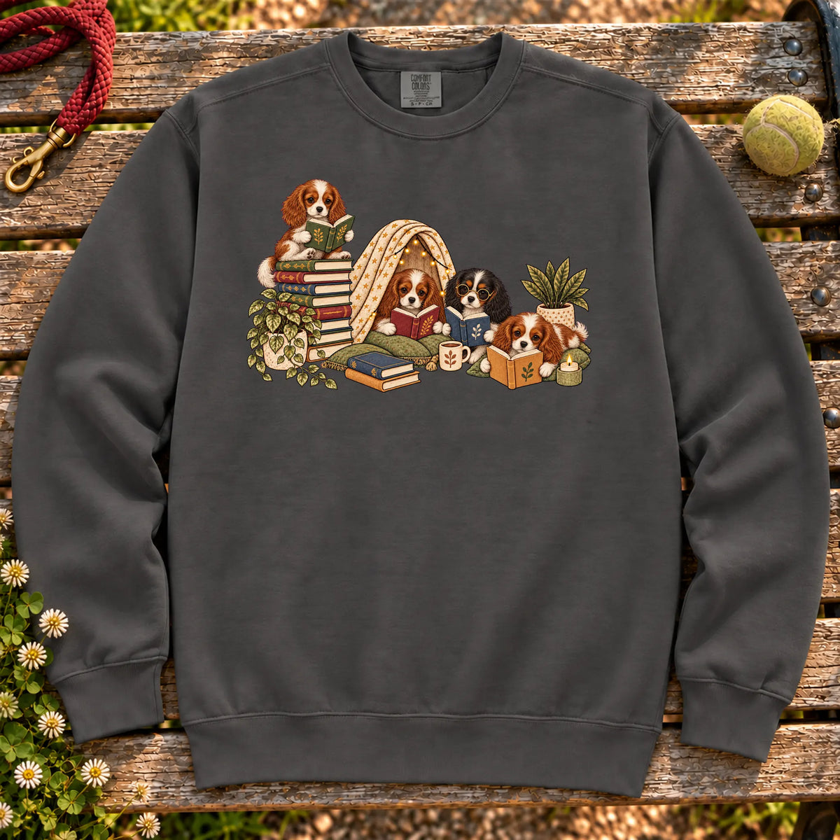 Cavalier King Charles Spaniel puppies reading books in a cozy blanket fort on a Pepper sweatshirt
