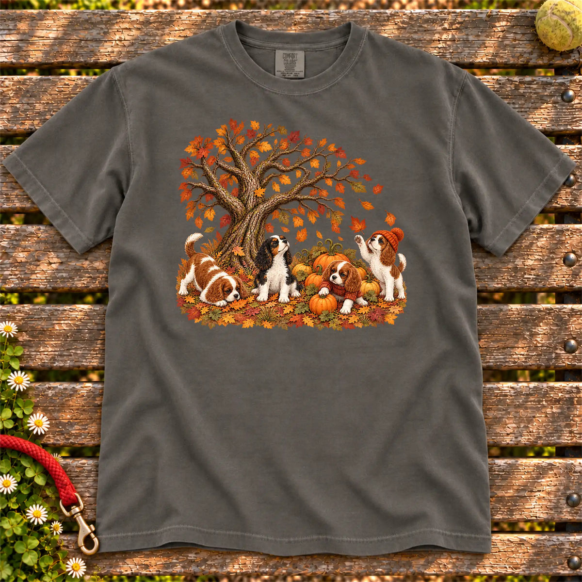 Four Cavalier King Charles Spaniel puppies with pumpkins beneath an autumn tree on a Pepper garment-dyed T-shirt