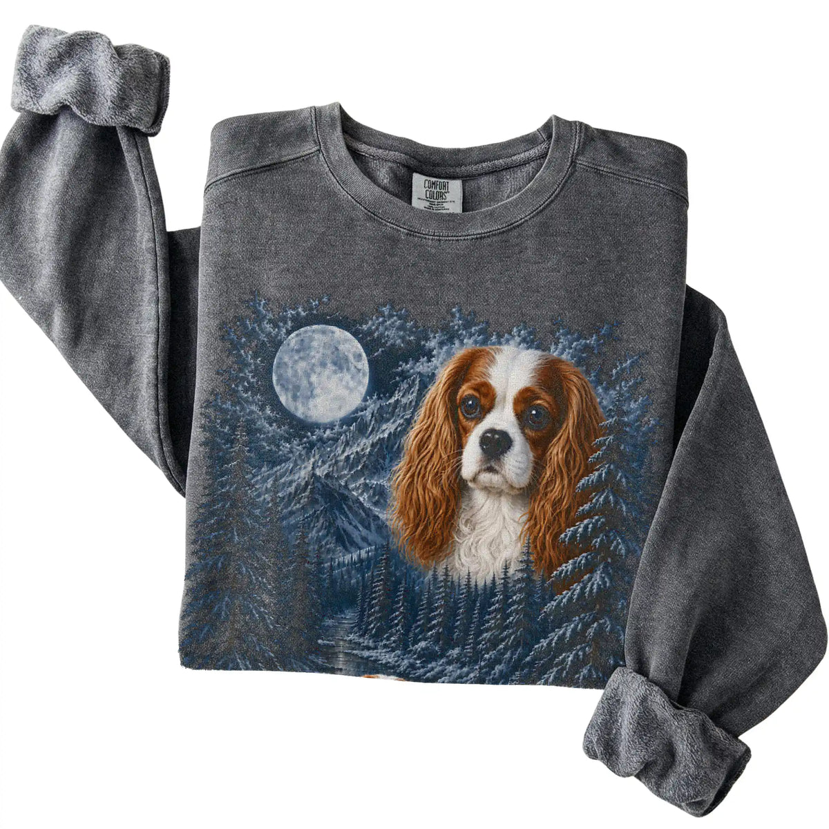 Folded pepper sweatshirt with Cavalier King Charles Spaniel Winter Moon artwork.
