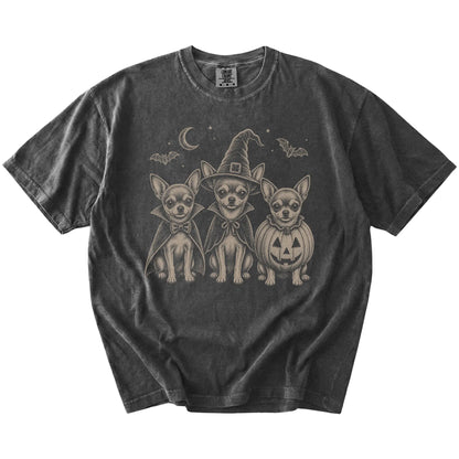 Three Chihuahua dogs dressed for Halloween beneath bats and a crescent moon on a Pepper Comfort Colors® T-shirt